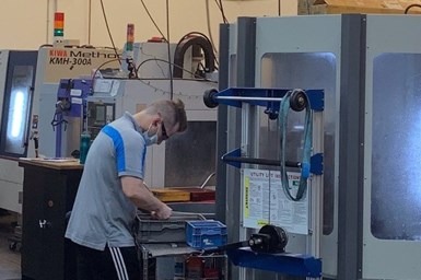 A photo of an employee at Alicat Scientific working near one of the company's Kiwa horizontal machining centers
